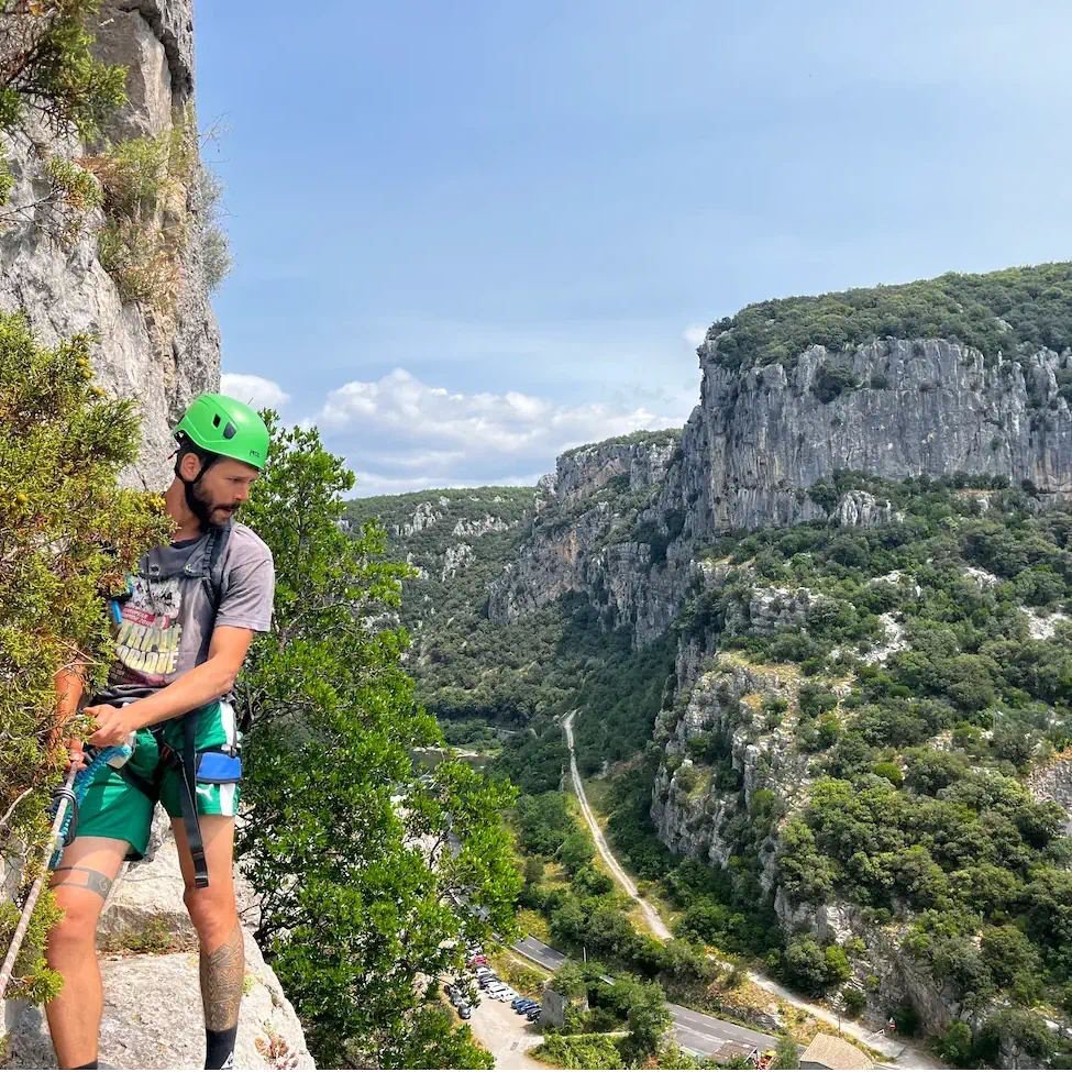grimpeur sur un passage aérien de la via ferrata du Rocher de Sion 